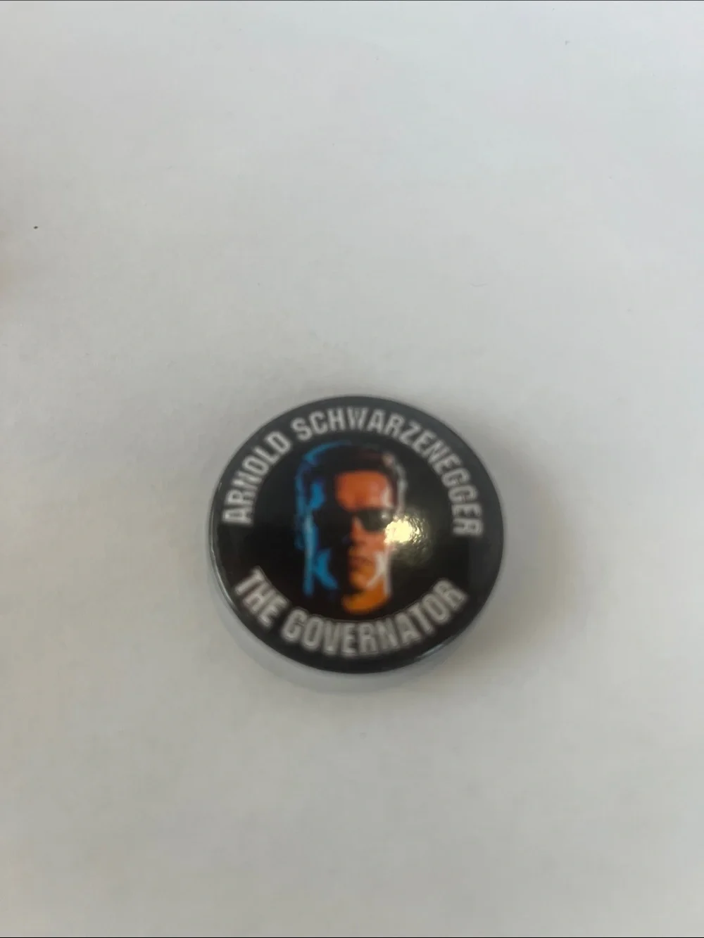 Arnold Schwarzenegger 'The Governator' Pin - Black with Blue & Orange